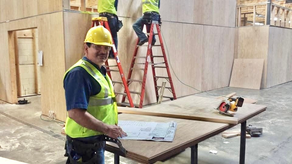 Fernandez Construction worker reviewing plans at a worksite